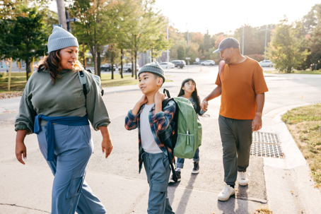 Two parents and two kids walking to school | Moreno Family Law